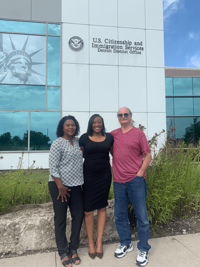 Three People in front of Building